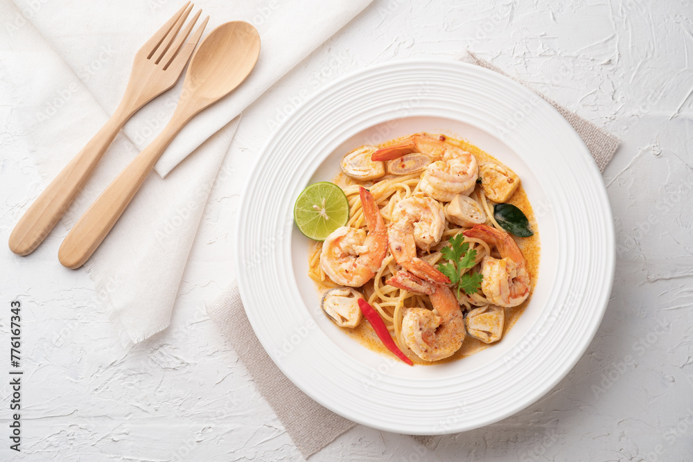 Stir fried Spaghetti with Shrimp,squid and straw mushroom in tom yum sauce.Thai fusion food Stir fried Spaghetti with Shrimp,squid and straw mushroom in tom yum sauce.Thai fusion food