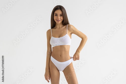 Fitness, skincare woman in underwear, smile and confident girl on grey studio background.