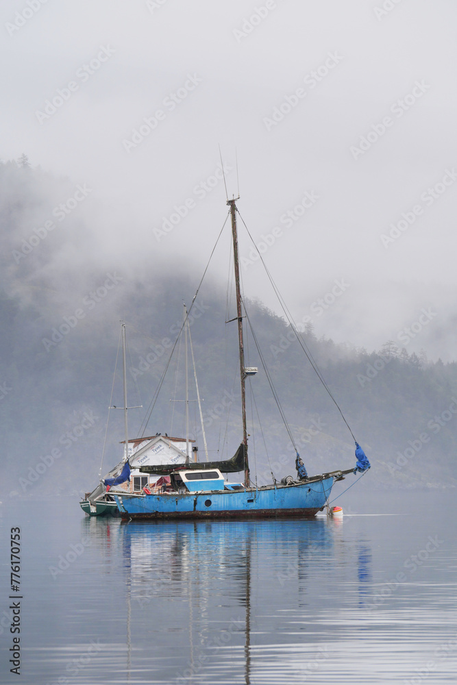 Boats in front of the shore of Cowichan Bay during a winter season on Vancouver Island in British Columbia, Canada