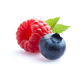Blueberry and raspberry in closeup with leaf