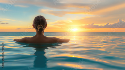 woman in pool on the beach at sunset
