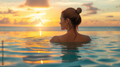 woman relaxing in the water at sunset