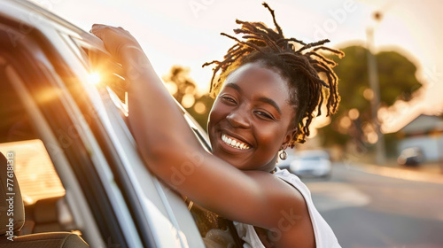 woman leaning out of car, smiling woman photo