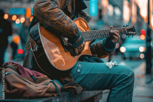 A photo of a lone street musician playing their guitar