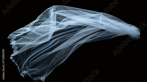 Flaying wedding white Bridal veil isolated on black background.  © paulmalaianu