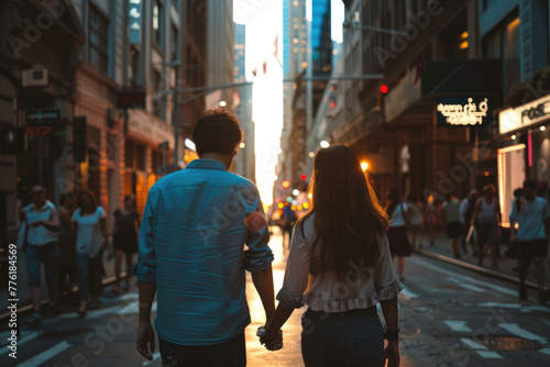 A couple walking hand-in-hand down a city street