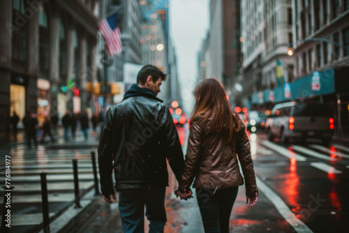 A couple walking hand-in-hand down a city street