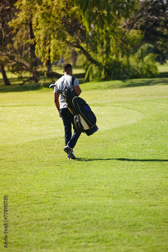 Sports, bag and walking on golf course with man or athlete outdoor on luxury holiday or vacation. Grass, field and exercise in summer on lawn with person in countryside for training or workout