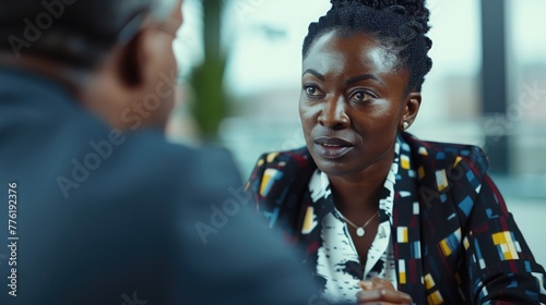A confident black businesswoman negotiating terms with a client, demonstrating assertiveness and strategic thinking in closing deals. photo