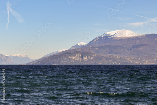 Lake Garda with Monte Baldo (2.218 m.), a mountain range in the Italian Alps whose summit can be reached by cable car from the lakeside town of Malcesine, Verona, Veneto, Italy © Simona Sirio