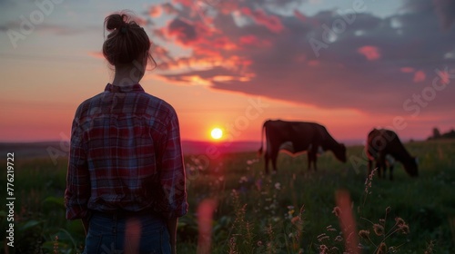 Person Standing in Field With Cows