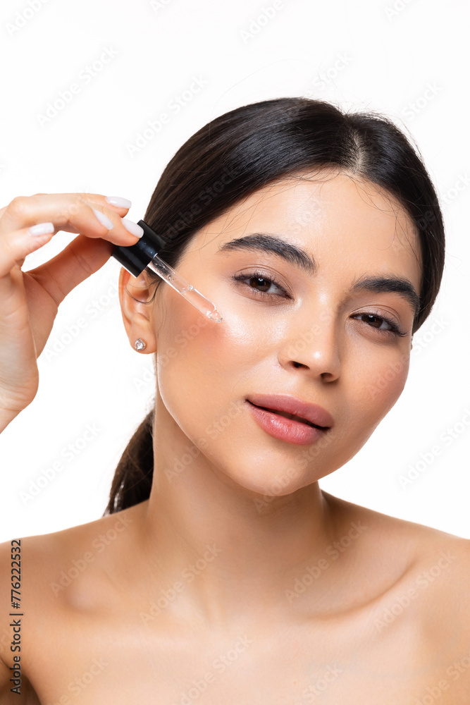 Beauty woman apply serum vitamin c, argan oil tea tree ingredients in pippette dropper under eye, treating skin