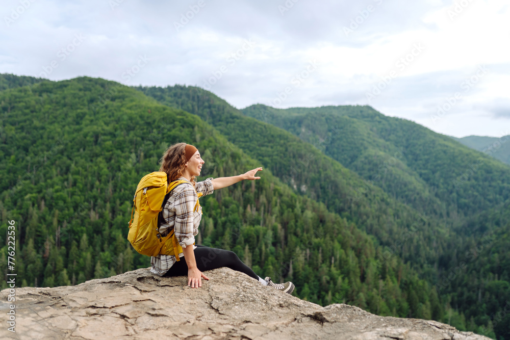 Naklejka premium Woman tourist on top of mountain enjoying views of nature. Lifestyle, adventure, nature, active life.