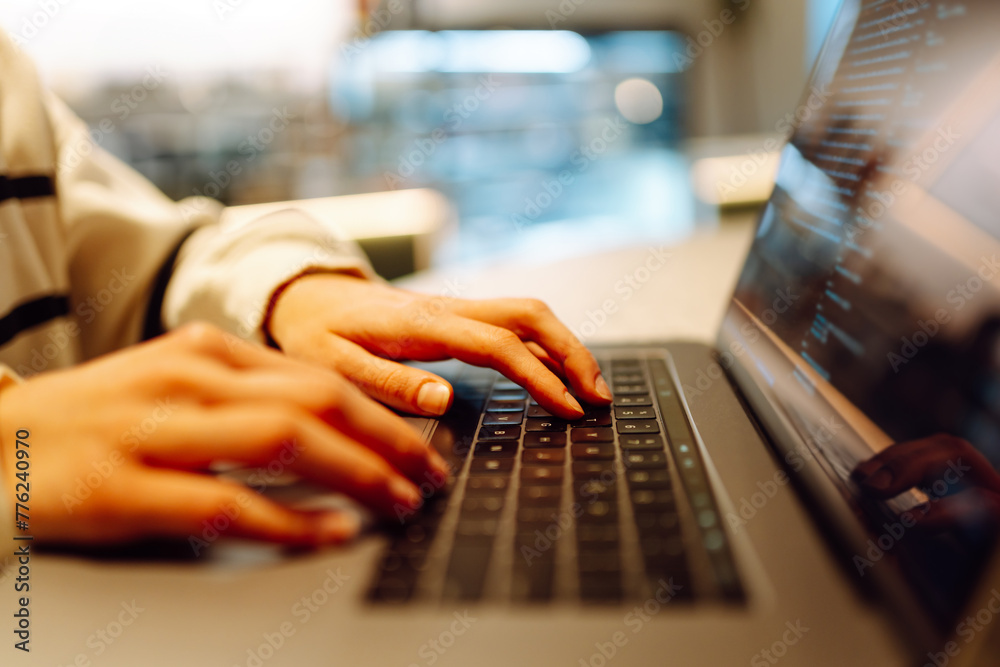 Close-up of hands working on a laptop keyboard. Freelance, online course. Shopping online. Cyber security concept Close-up of hands working on a laptop keyboard. Freelance, online course. Shopping online. Cyber security concept
