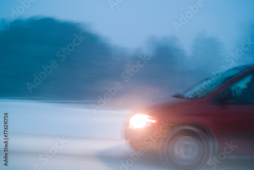 Car driving through winter snow storm