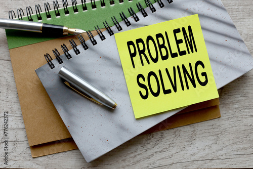 problem solving text on a sticker on a gray notepad