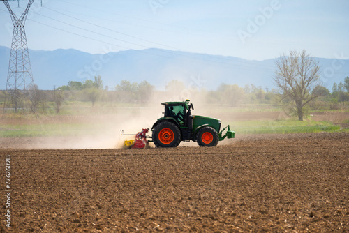 side view of tractor preparing the fields for cultivation