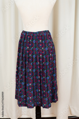 Colorful skirt with a floral folk-art pattern. A garment photographed on a dress form. 