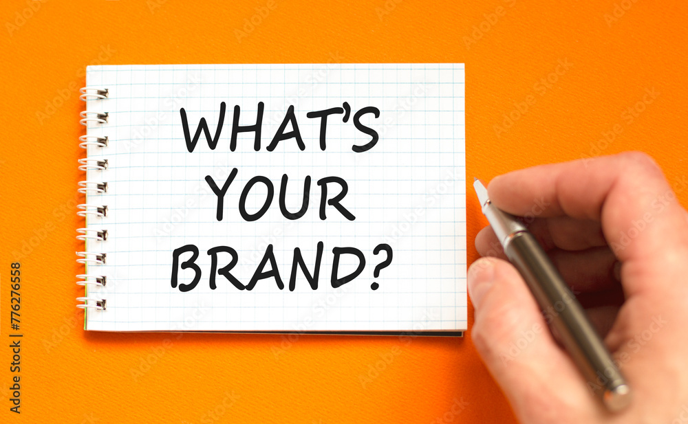 Branding what is your brand symbol. Concept words What is your brand on beautiful white note. Beautiful orange background. Businessman hand. Business branding what is your brand concept. Copy space. Branding what is your brand symbol. Concept words What is your brand on beautiful white note. Beautiful orange background. Businessman hand. Business branding what is your brand concept. Copy space.