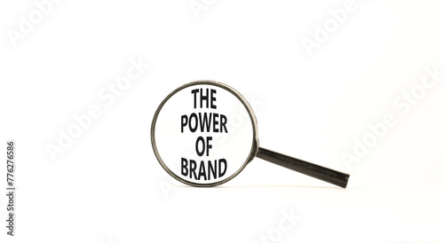 The power of brand symbol. Concept words The power of brand on beautiful magnifying glass. Beautiful white table white background. Business the power of brand concept. Copy space.