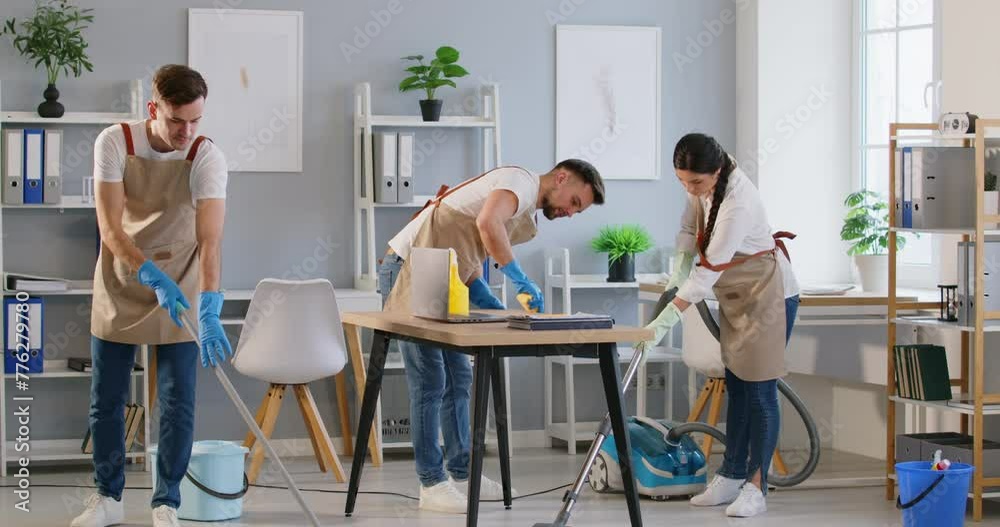 Cleaning team focuses on detailed cleaning of office space to ensure perfect cleanliness. Team of cleaners with gloves and aprons cleans office, demonstrating high quality of cleaning services. Cleaning team focuses on detailed cleaning of office space to ensure perfect cleanliness. Team of cleaners with gloves and aprons cleans office, demonstrating high quality of cleaning services.