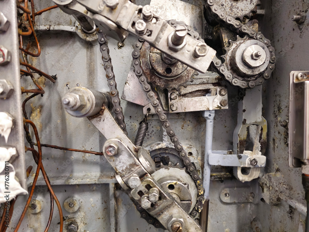 Sprockets and drive chain in an old industrial machine. Keeping machines in full working condition