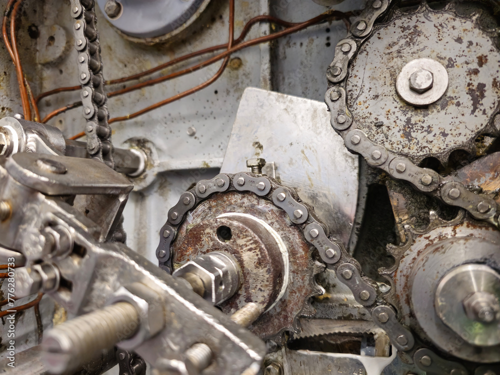 Sprockets and drive chain in an old industrial machine. Keeping machines in full working condition