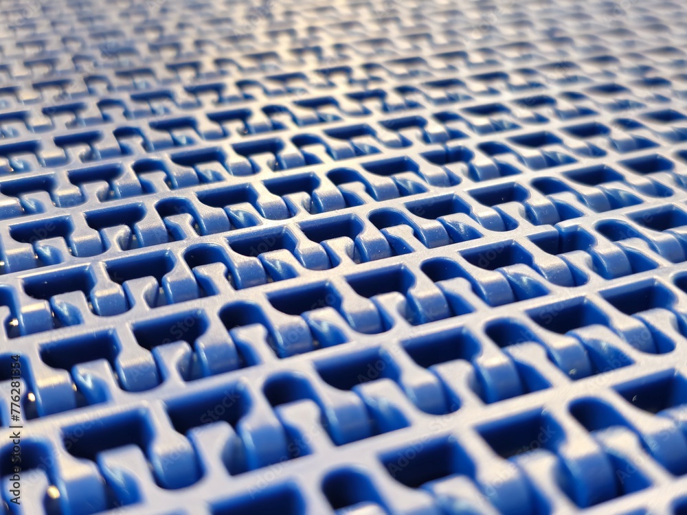 A close-up of a blue polyurethane belt in modular industrial conveyor system. Transport systems in industrial factories.