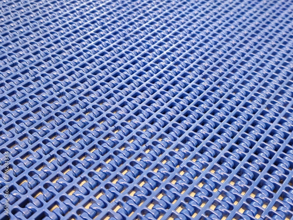 A close-up of a blue polyurethane belt in modular industrial conveyor system. Transport systems in industrial factories.