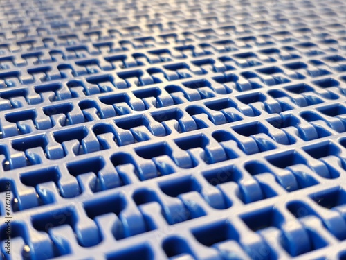 Obraz na płótnie A close-up of a blue polyurethane belt in modular industrial conveyor system. Transport systems in industrial factories. w salonie