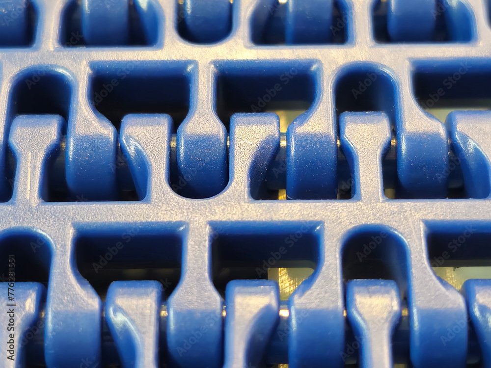 A close-up of a blue polyurethane belt in modular industrial conveyor system. Transport systems in industrial factories.