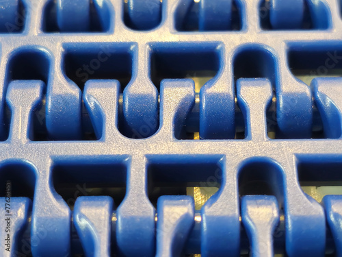 Obraz na płótnie A close-up of a blue polyurethane belt in modular industrial conveyor system. Transport systems in industrial factories. w salonie