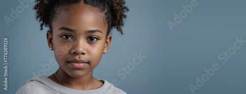 An African American Juvenile Girl, Isolated On A Grey-Blue Background With Copy Space photo