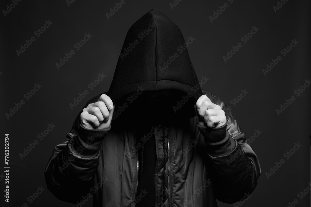 Stylish Man in Black Hood. Trendy wear Boy in a hooded sweatshirt - obrazy, fototapety, plakaty 