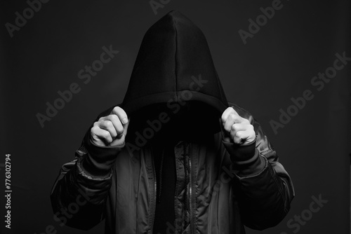 Stylish Man in Black Hood. Trendy wear Boy in a hooded sweatshirt