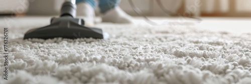 Vacuum cleaner in use on a white shag carpet. Rug cleaning. Vacuuming. Concept of household chores, home hygiene, carpet grooming, and professional cleaning service. Wide Banner. Copy space photo