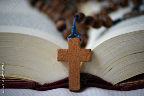 Holly Bible and wooden cross with rosary