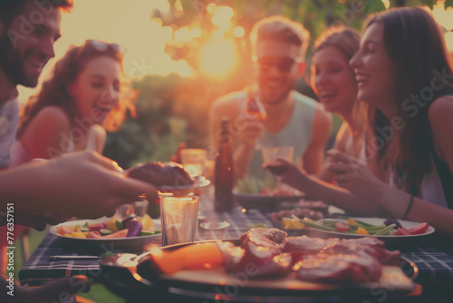 Friends enjoying a barbecue at sunset