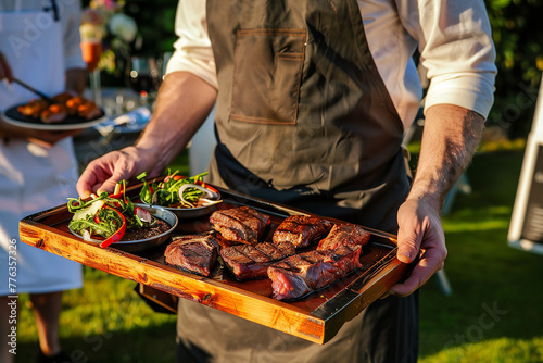 Waiter serving grilled steak and salad at an event © zphoto83