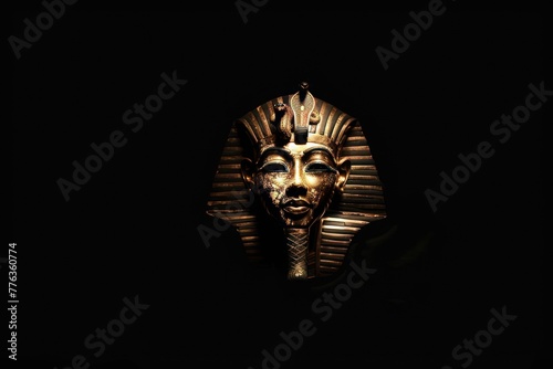 Pharaoh Tutankhamuns golden death mask on black background photo