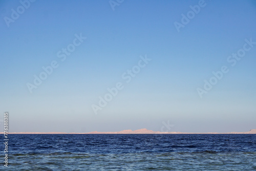 Red sea in Egypt and Tiran island (Saudi Arabia) arid mountains in the distance