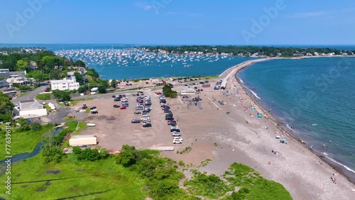 Flying over Devereux Beach and Marblehead Harbor with yachts docked in the harbor in town of Marblehead, Massachusetts MA, USA.  photo