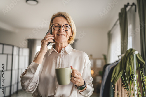 portrait of mature woman make a phone call at office happy smile