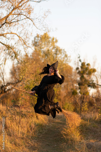 A witch dressed in black dress in the forest  © PumpedVisuals