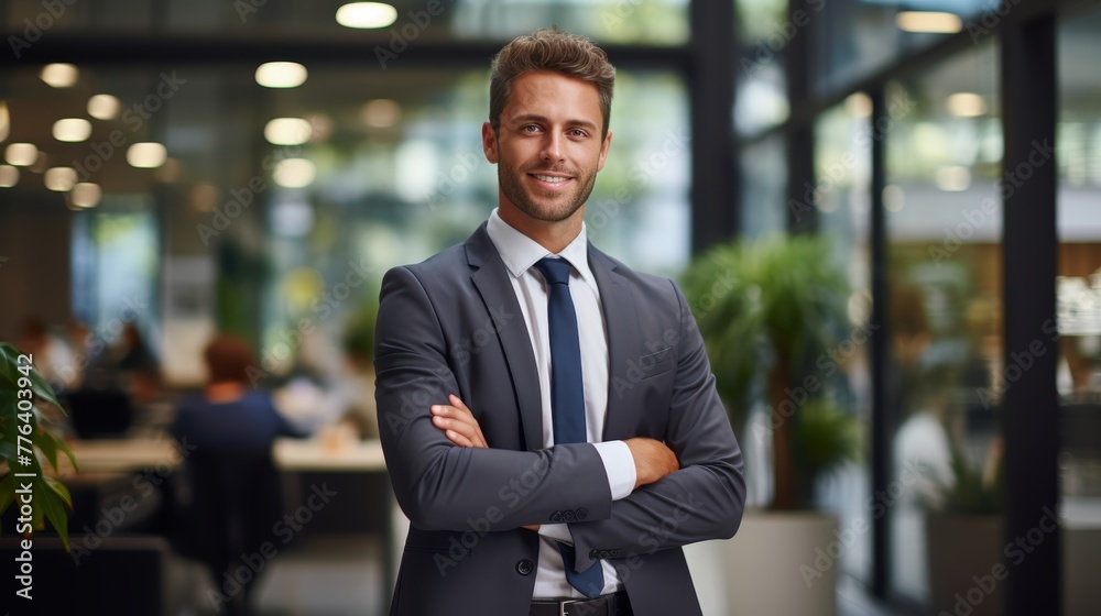 Portrait of a smiling businessman standing with arms crossed in an office Portrait of a smiling businessman standing with arms crossed in an office