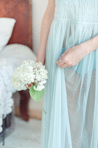 Woman in Blue Dress Holding Bouquet of Flowers