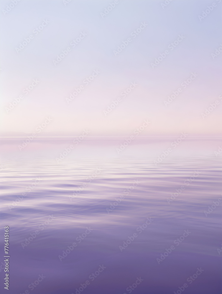 A calm body of water with a light blue sky in the background. The water is still and the sky is a soft, pastel color