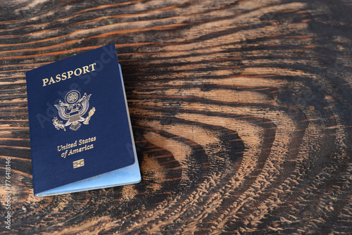US citizen passport on a wooden table. Space for text.