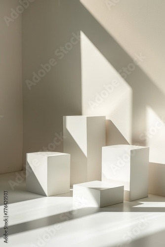Elegant modern geometric style of showcase for cosmetics product display - white square podiums in sunlight with shadow in white background, vertical © Aliaksandr Siamko