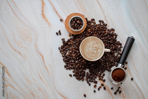 Composition with cup of coffee, beans and powder on light marble table background. Coffee concept. Coffee background.